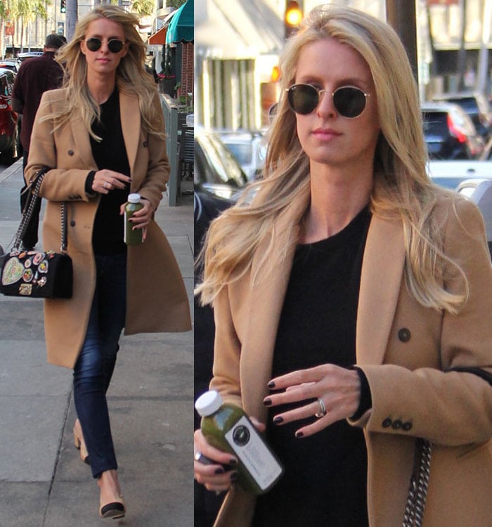 Nicky Hilton carries a bottle of juice in a camel coat and a pair of Rag & Bone skinny jeans