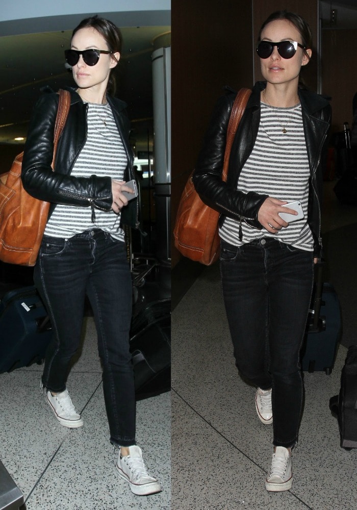 Olivia Wile wears a striped shirt and skinny jeans as she strolls through LAX