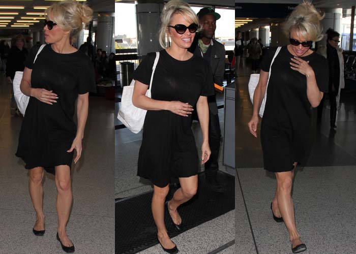 Pamela Anderson wears a black shirtdress at LAX