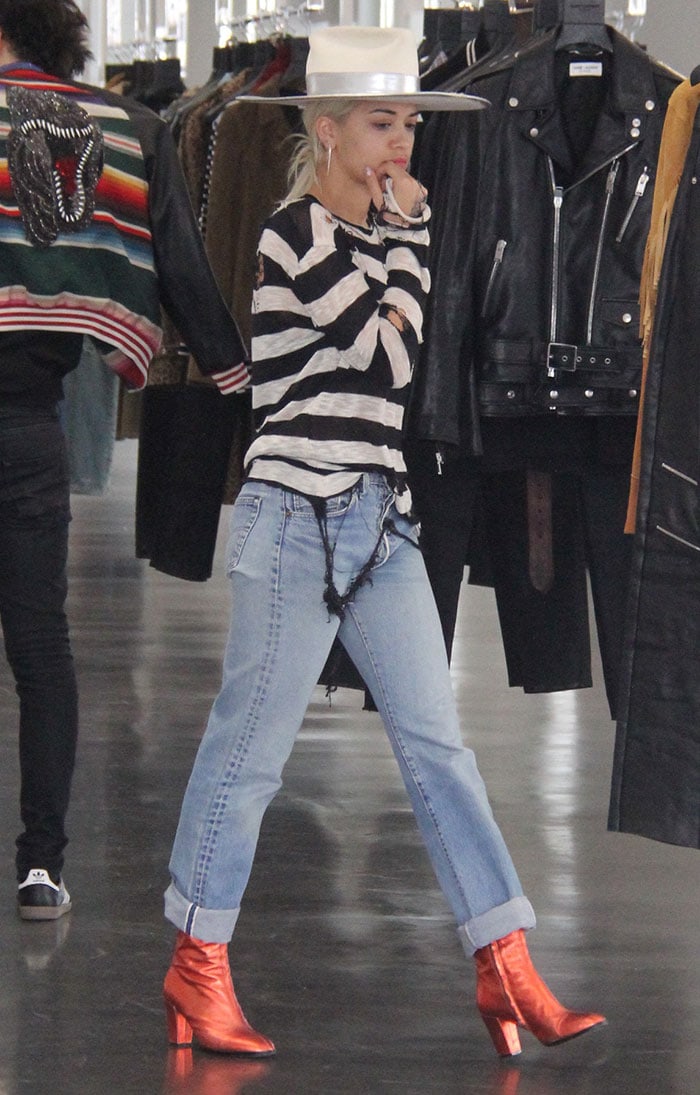 Rita Ora ditches her denim vest to show off her black-and-white striped shirt while out shopping