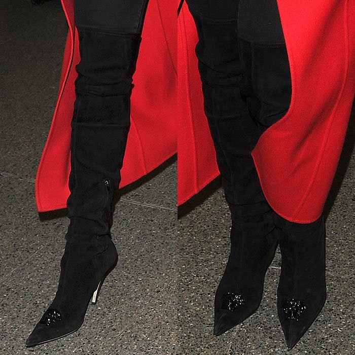 Rita Ora wears black suede thigh-high Versace boots through King's Cross