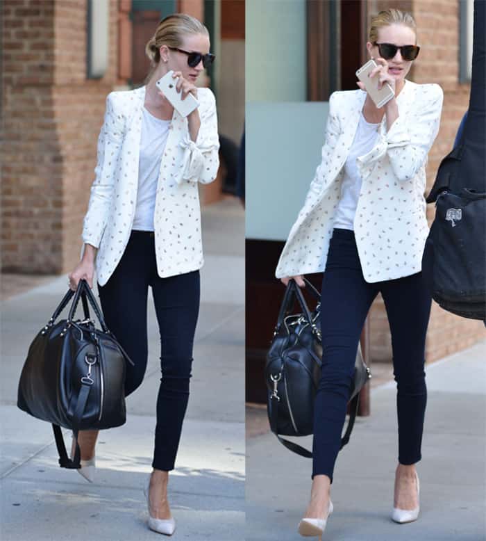 Rosie Huntington-Whiteley exudes elegance in a white patterned blazer, paired with a simple white tee, skinny black jeans, and classic pumps, completing the look with a large black handbag