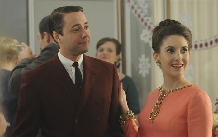 Vincent Kartheiser as Pete Campbell and Alison Brie as Trudy Campbell attend a holiday party in a scene from Mad Men, showcasing classic 1960s fashion