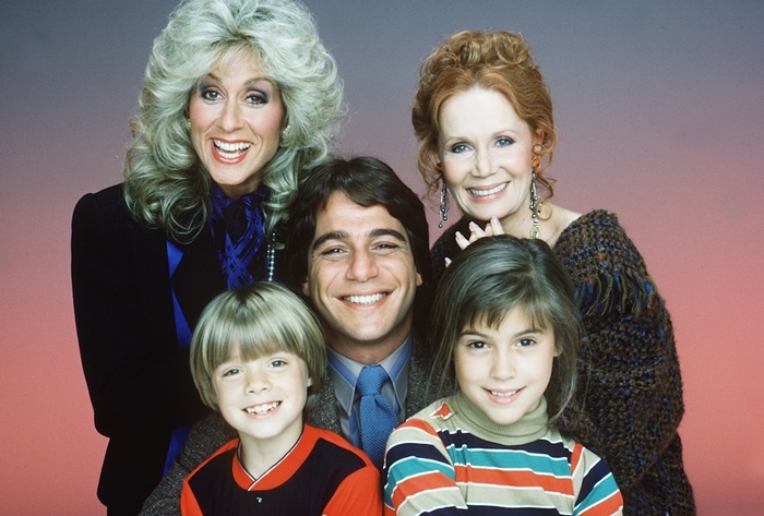 The cast of 'Who's the Boss?' featuring Tony Danza, Alyssa Milano, Judith Light, Danny Pintauro, and Katherine Helmond gathered on set, capturing the essence of the beloved sitcom