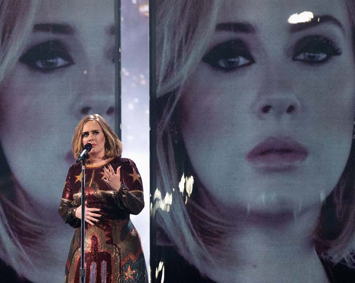 Adele wears a Valentino dress on stage while performing at the BRIT Awards
