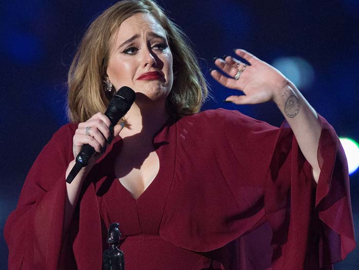 Adele performs at the BRIT Awards in a Giambattista Valli dress