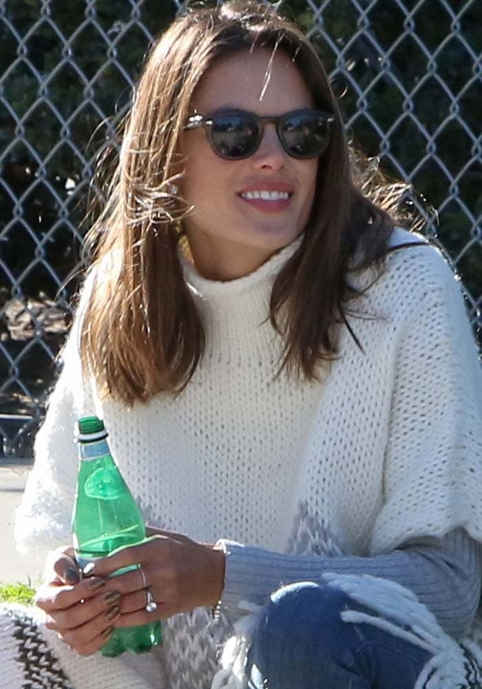 Alessandra Ambrosio wears a knitted poncho by Elizabeth & James