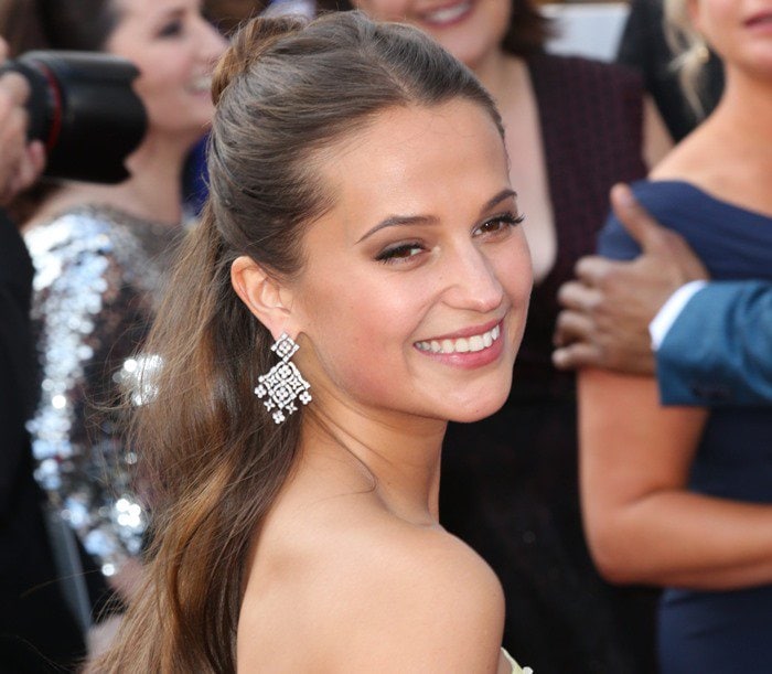 Alicia Vikander shows off her statement earrings from Louis Vuitton