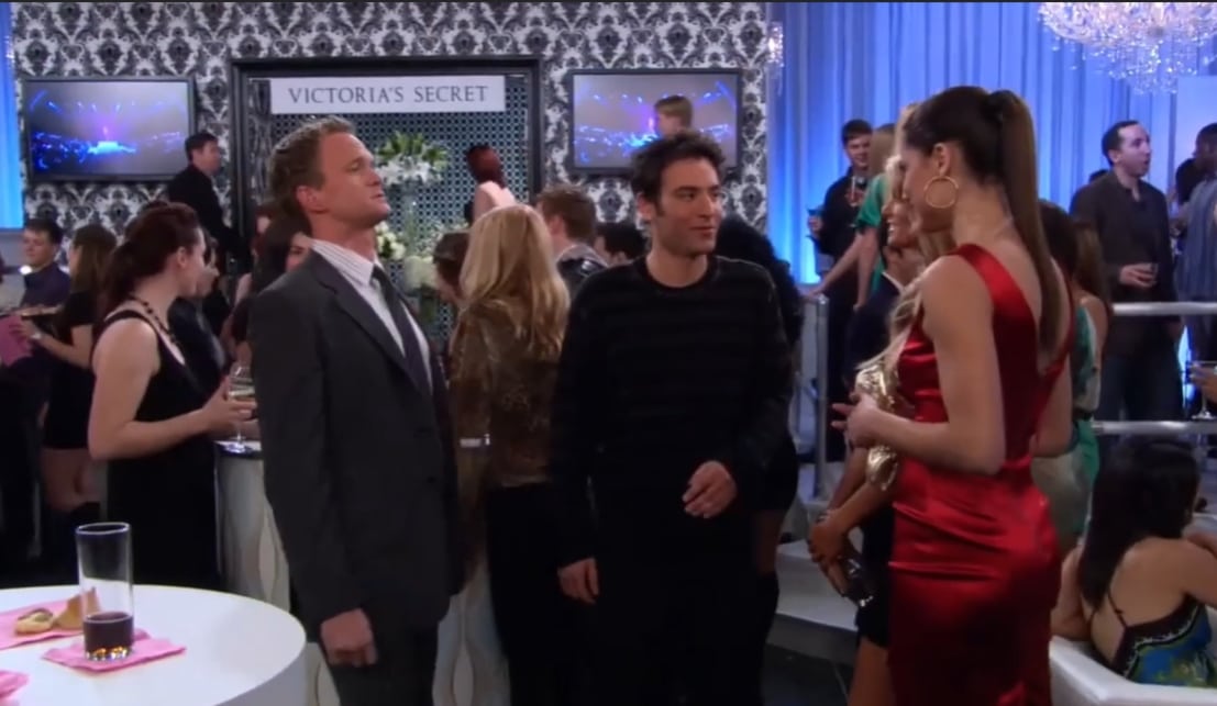 Neil Patrick Harris as Barney Stinson and Josh Radnor as Ted Mosby enter the Victoria's Secret after-party and attempt to engage Adriana Lima in conversation