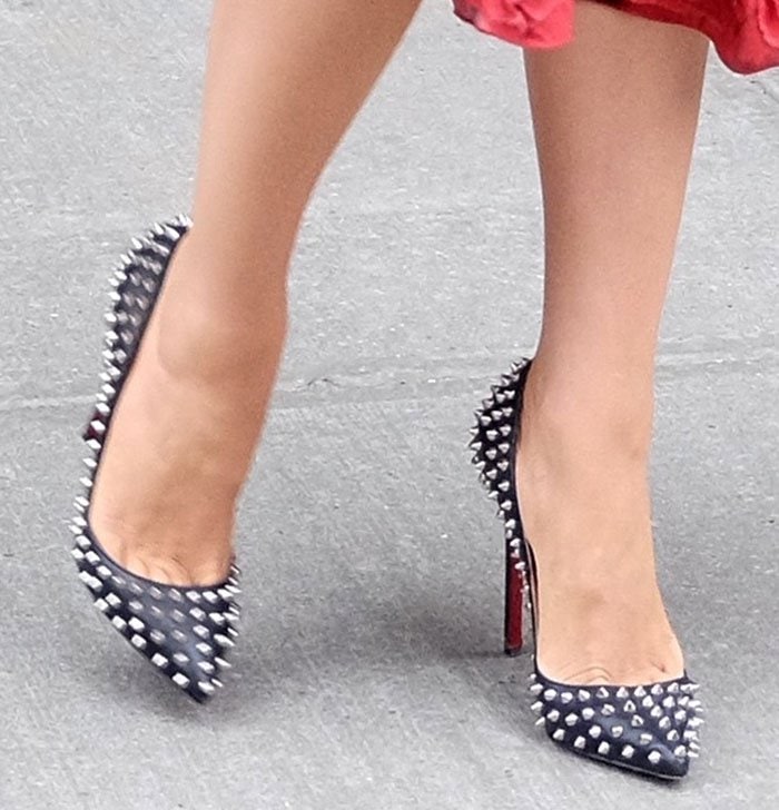Blake Lively steps out in edgy black Christian Louboutin pumps, featuring bold silver spikes, pointed toes, and signature red soles