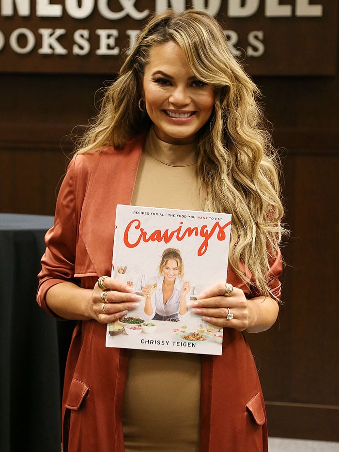 Chrissy Teigen wears her hair down in curls at her book signing for "Cravings: Recipes For All The Food You Want To Eat"