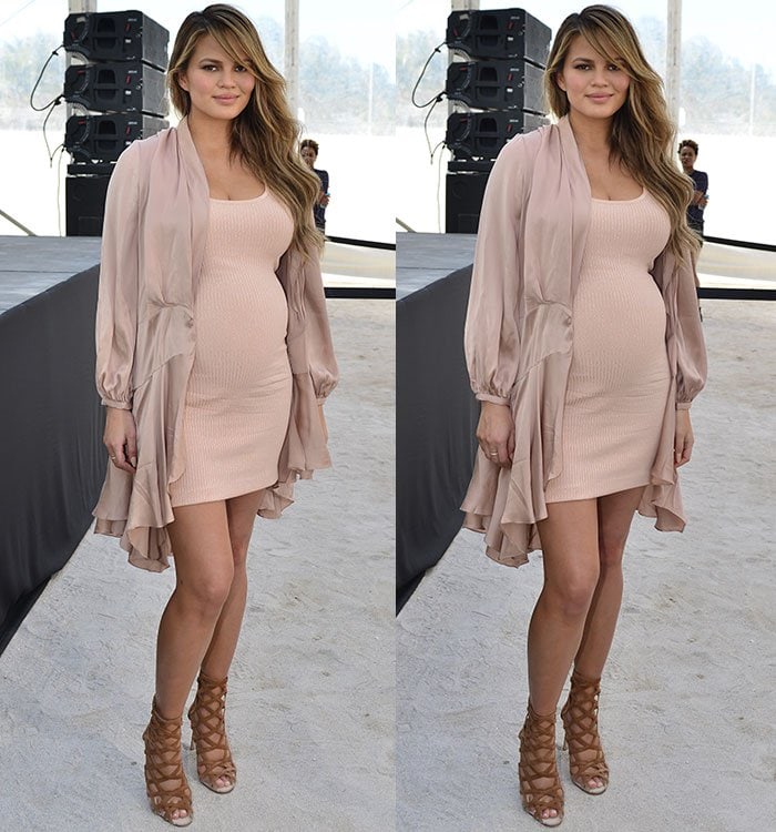 Chrissy Teigen shows off her baby bump in a blush-covered dress and matching jacket