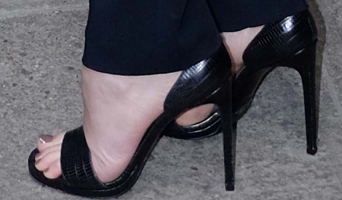 Dakota Johnson's feet in reptile-embossed Saint Laurent sandals