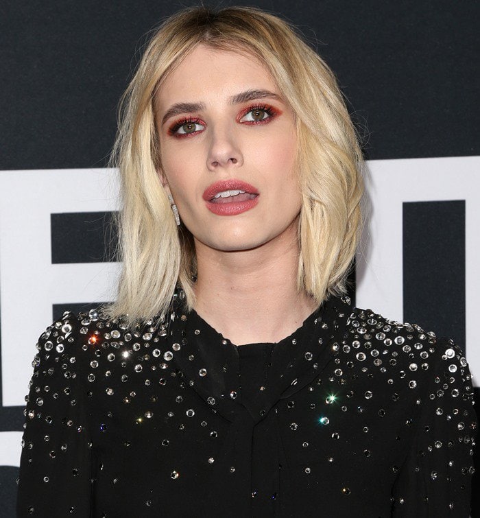 Emma Roberts wears an embellished Saint Laurent blouse as part of her all-black look