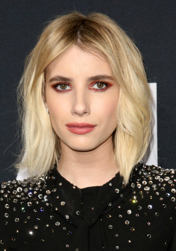 Emma Roberts shows off her new short blonde hair at the Saint Laurent fashion show