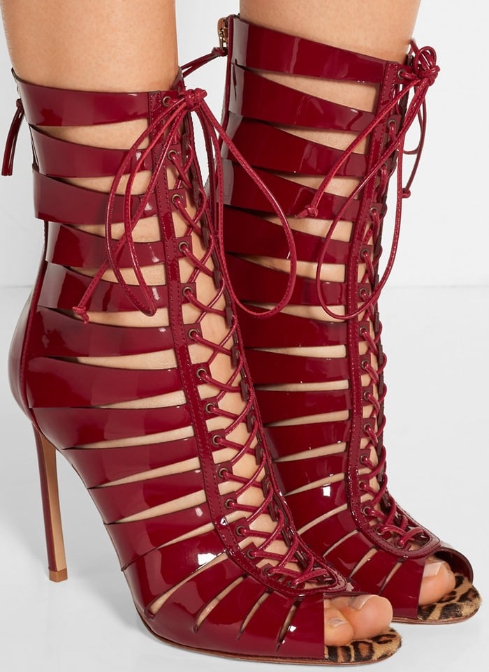 These caged sandals are crafted from rich burgundy patent-leather with a lace-up front