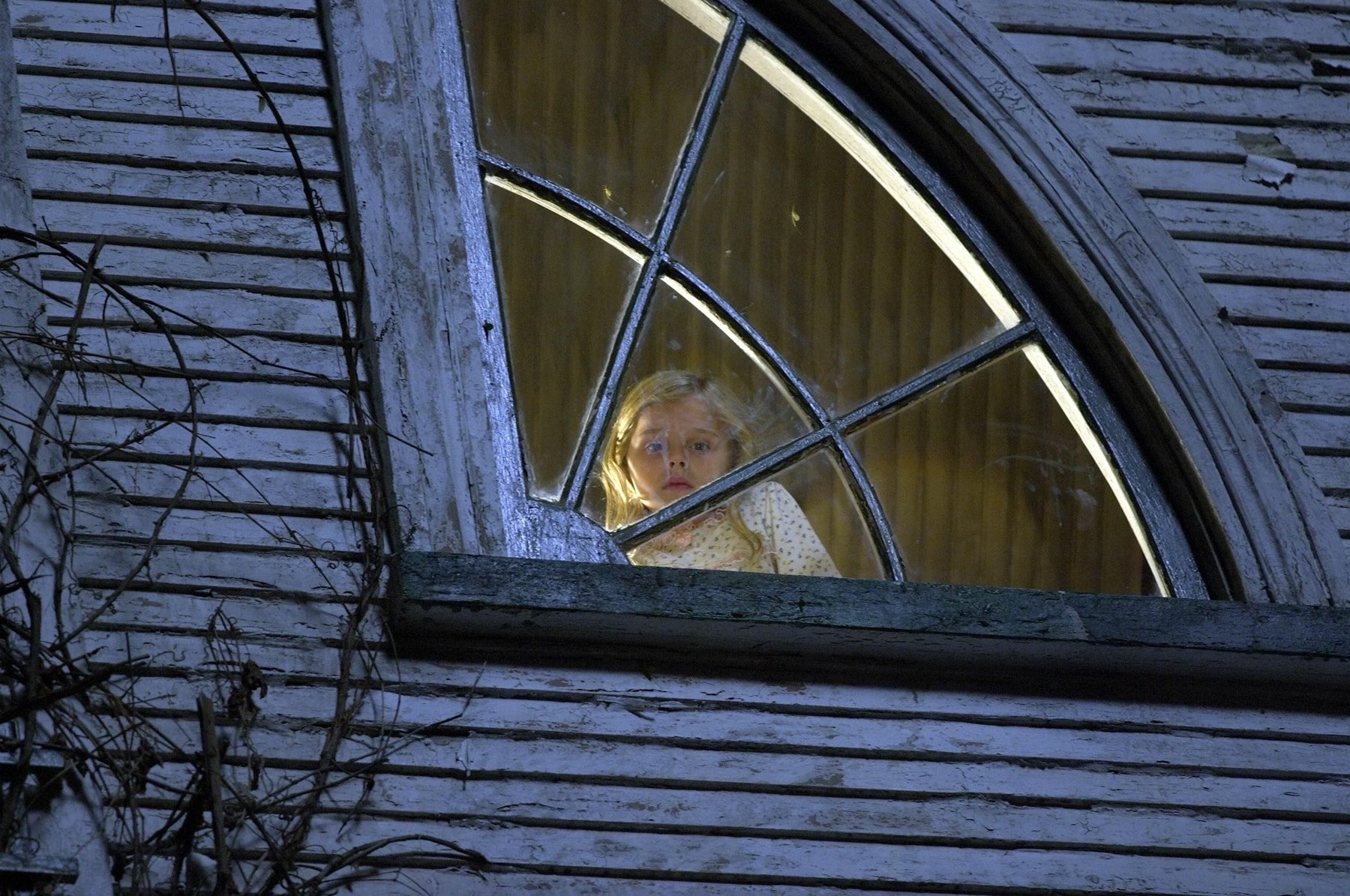 Chloë Grace Moretz captures the eerie atmosphere as Chelsea Lutz in a tense scene from The Amityville Horror