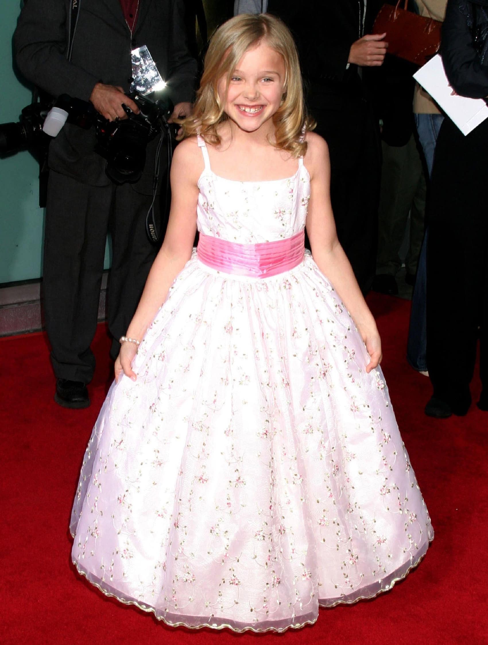Chloë Grace Moretz looks adorable in a pink floral embroidered gown with a matching pink waistband at the premiere of The Amityville Horror