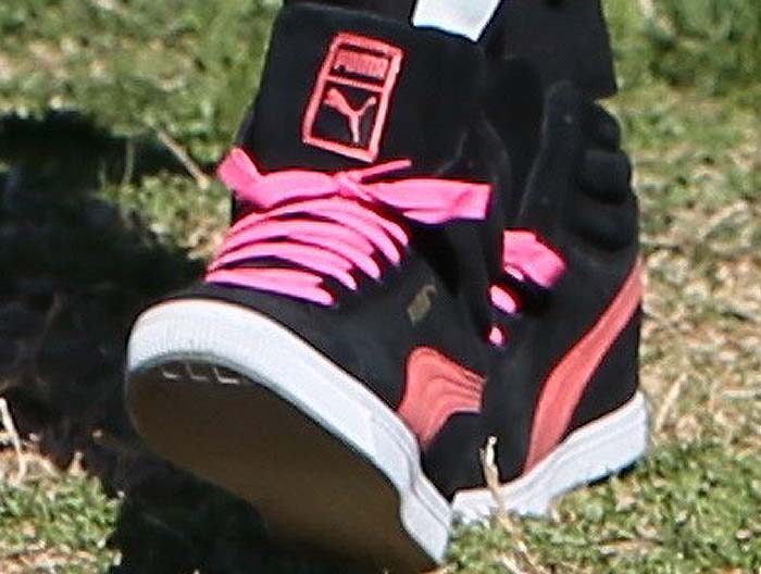 Gwen Stefani's feet in pink Puma wedge sneakers