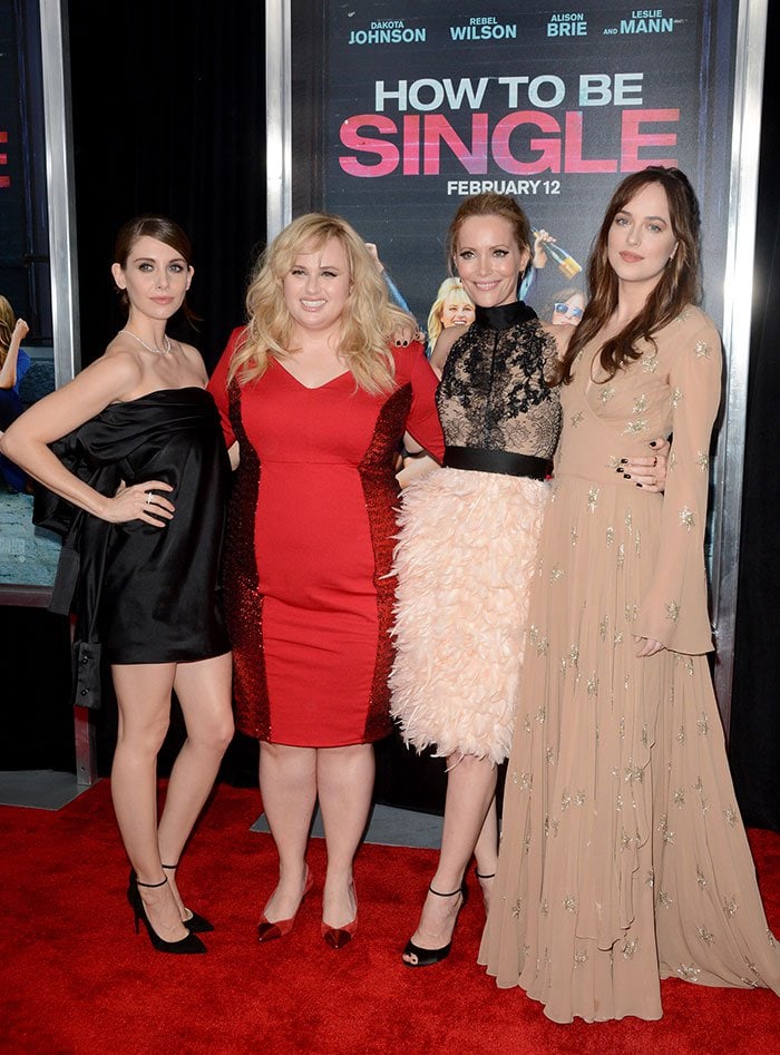 Alison Brie, Rebel Wilson, Leslie Mann, and Dakota Johnson pose on the red carpet of the premiere of "How to Be Single"