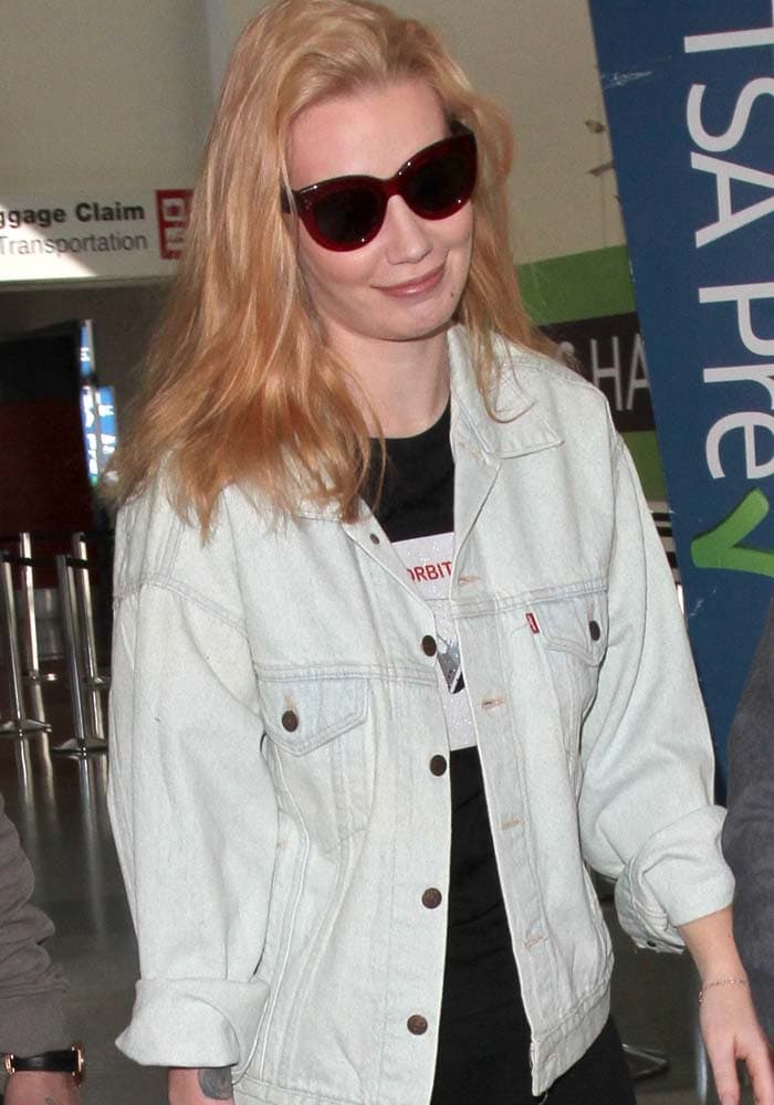 Iggy Azalea flaunts her still pinkish hair as she arrives at Los Angeles International Airport