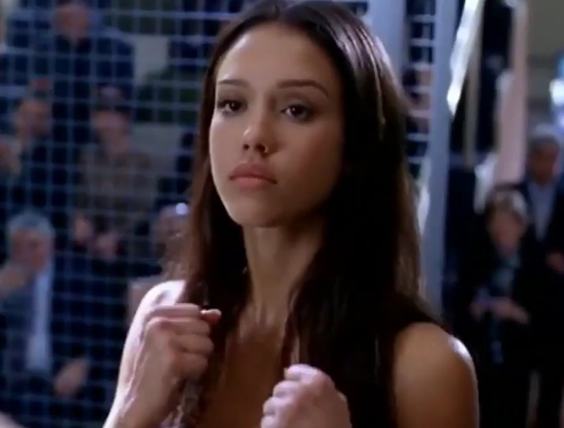 Jessica Alba as Max Guevara in Dark Angel, ready to fight in a tense scene that highlights her character's strength and determination