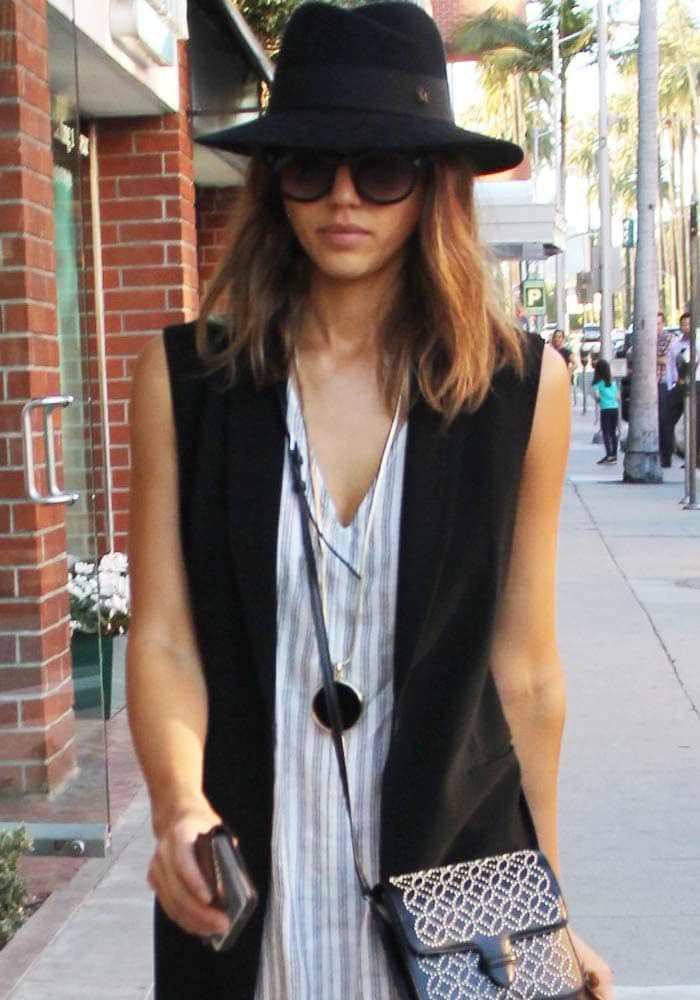 Jessica Alba covers her hair with a hat as she leaves a doctor's office