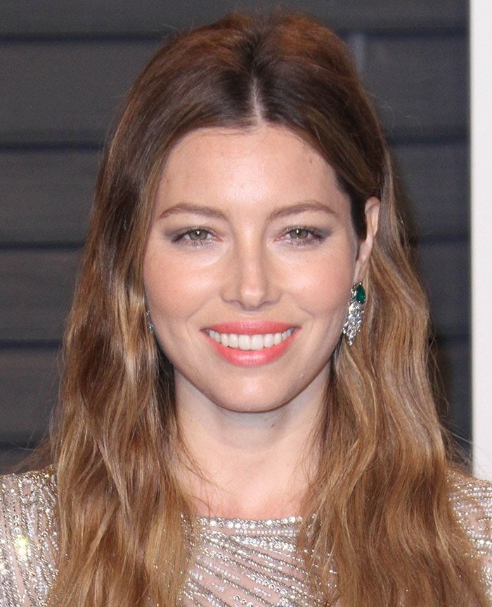 Jessica Biel wears a pair of emerald and diamond earrings and keeps her makeup light