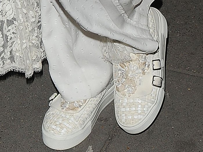 Karlie Kloss wears buckled white woven Alexander McQueen sneakers