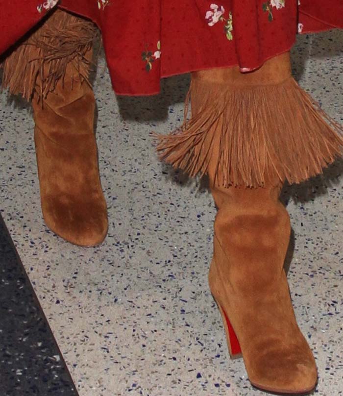 Kate Hudson wears a fringed pair of Christian Louboutin boots through LAX