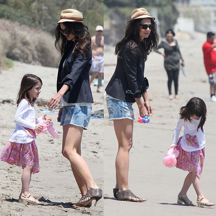 Katie Holmes and daughter Suri Cruise at a Memorial Day beach party in Malibu, California, on May 30, 2011.