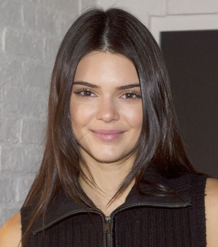 Kendall Jenner's center-parted dark locks and a barely there makeup finished off her look