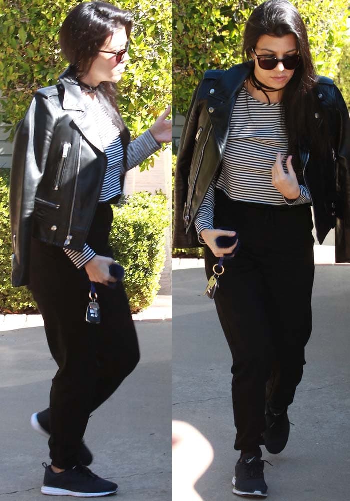 Kourtney Kardashian wears a Saint Laurent leather jacket with a Chelsea28 slim-fitting top patterned with slender stripes