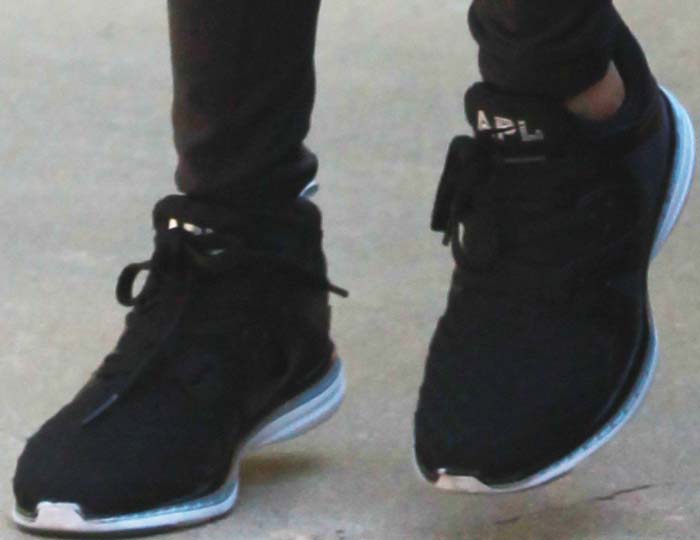 Kourtney Kardashian wears a pair of APL sneakers hiking