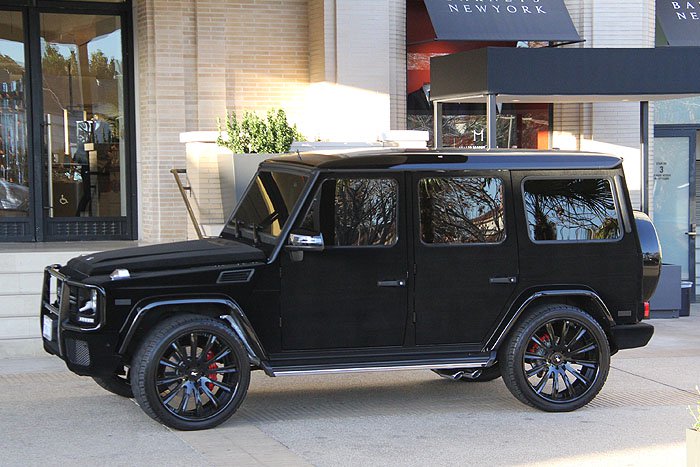 Kylie Jenner's black-velvet-wrapped Mercedes-Benz G Wagon (customized by West Coast Customs) waits for her outside Barneys New York in Beverly Hills