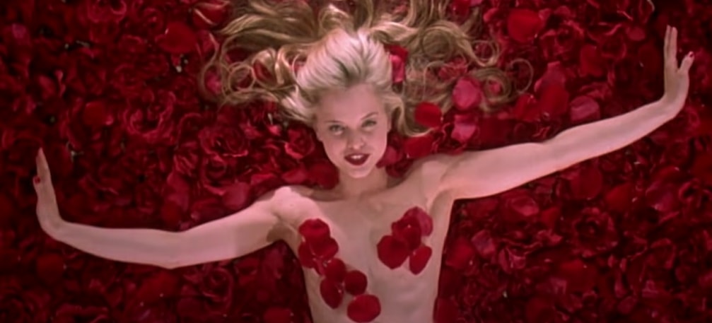 Mena Suvari in the iconic rose petal scene from the 1999 film American Beauty, where she portrays Angela Hayes