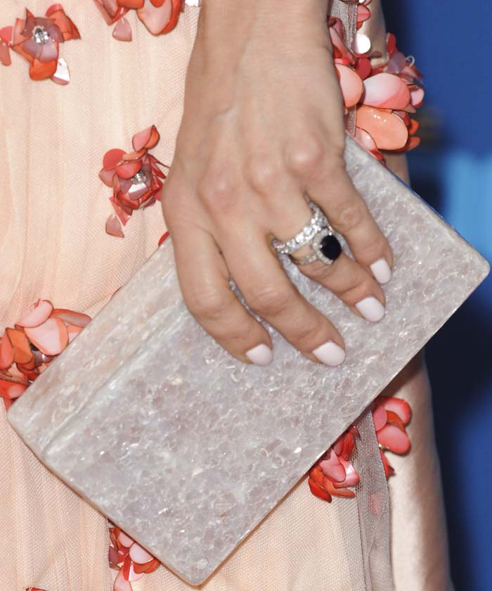 Mena Suvari holds a rectangular Edie Parker clutch