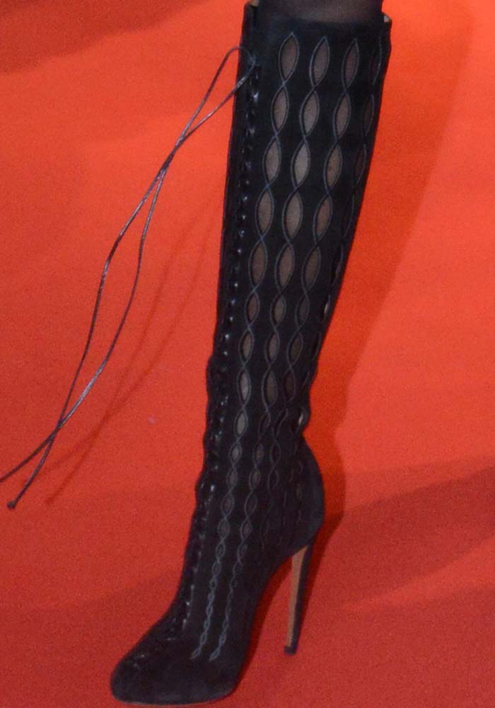 Naomi Campbell wearing knee-high embroidered lace-up boots by Alaïa