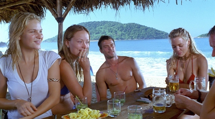 Beau Garrett, Olivia Wilde, Josh Duhamel, and Melissa George sharing a relaxed moment on set in Turistas, the 2006 American horror film set against the stunning beaches of Brazil