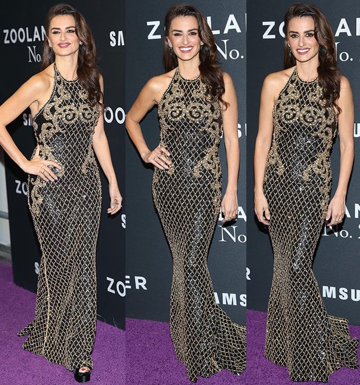 Penélope Cruz stuns in a floor-length black-and-gold Balmain gown reportedly paired with Brian Atwood sandals