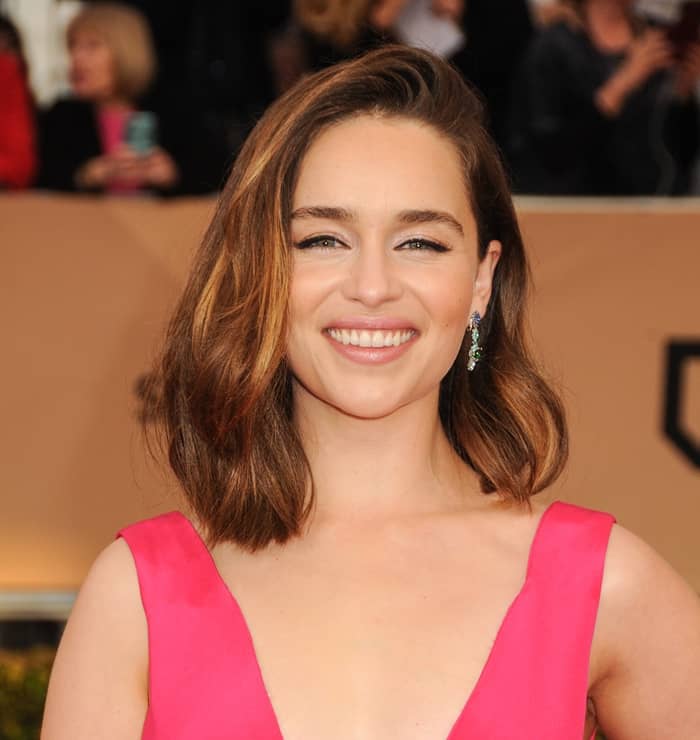 Emilia Clarke looked every bit the Disney princess and accessorized with green and blue jewels from the same fashion house
