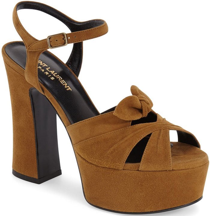 Retro-chic leather sandal fashioned with a slim ankle strap and a graceful bow embellishment