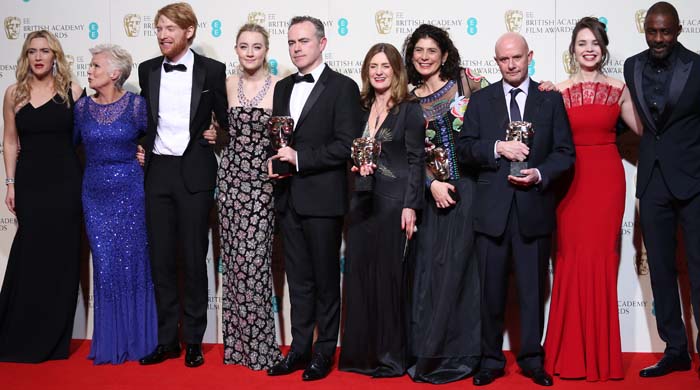 Kate Winslet, Julie Walters, Domhnall Gleeson, Saoirse Ronan, John Crowley, Finola Dwyer, Amanda Posey, Nick Hornby, guest, and Idris Elba pose with the Outstanding British Film award for 'Brooklyn' in the winners' room at the EE British Academy Film Awards