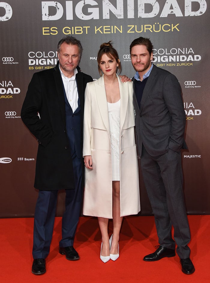 Michael Nyqvist, Emma Watson, and Daniel Bruhl pose for photos on the red carpet at the Berlin premiere of "Colonia"