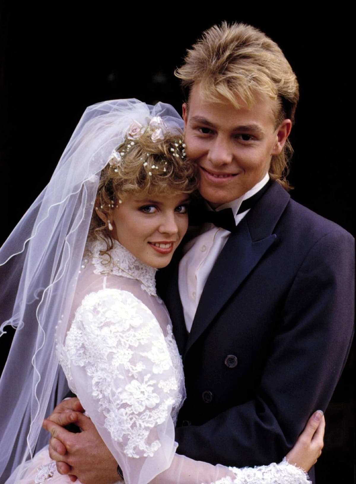 Kylie Minogue and Jason Donovan as Charlene and Scott in their iconic wedding scene from Neighbours, a moment that became one of the most memorable in soap opera history