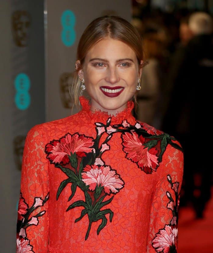 Dree Hemingway in a high-necked red lace gown adorned with flowers from Erdem's pre-fall 2016 collection at the EE British American Film Awards