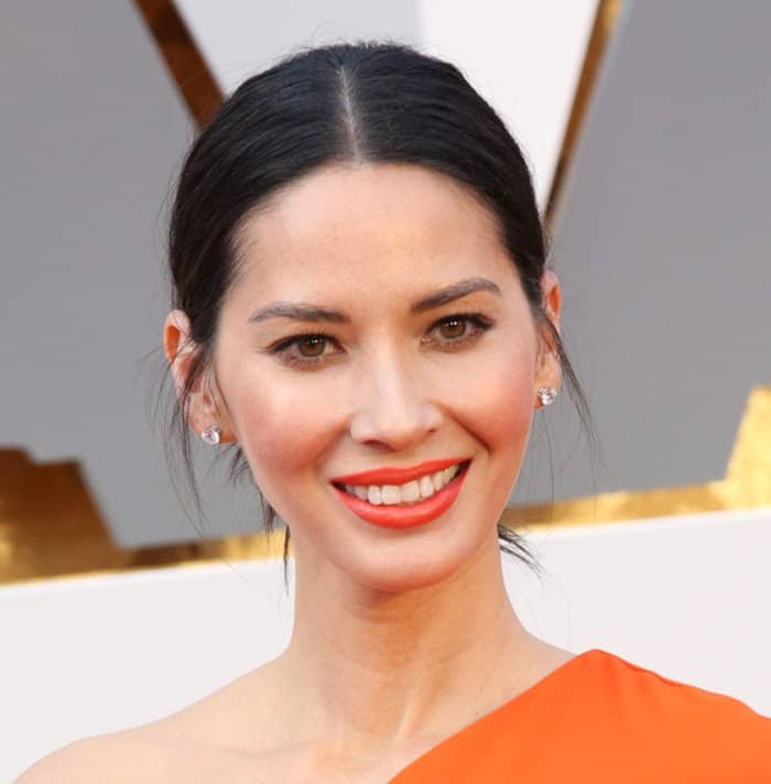 Olivia Munn shows off her diamond stud earrings