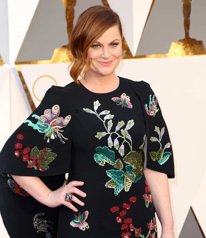 Amy Poehler embraces a springtime vibe in an André Gn gown with bold garden embroidery at the 88th Annual Academy Awards