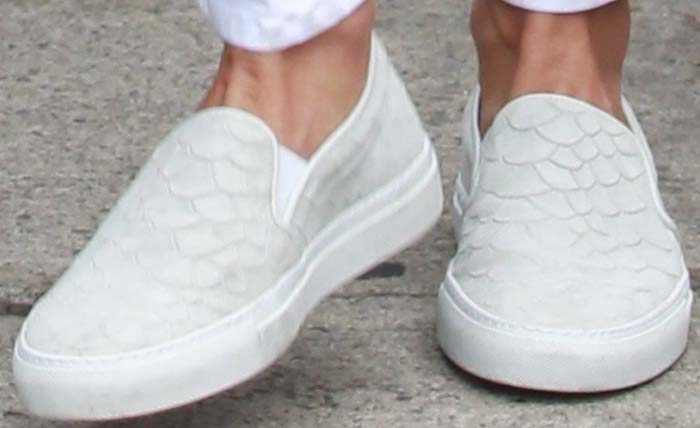 Alessandra Ambrosio puts a little class into her white slip-on shoes by opting for a snakeskin-embossed pattern
