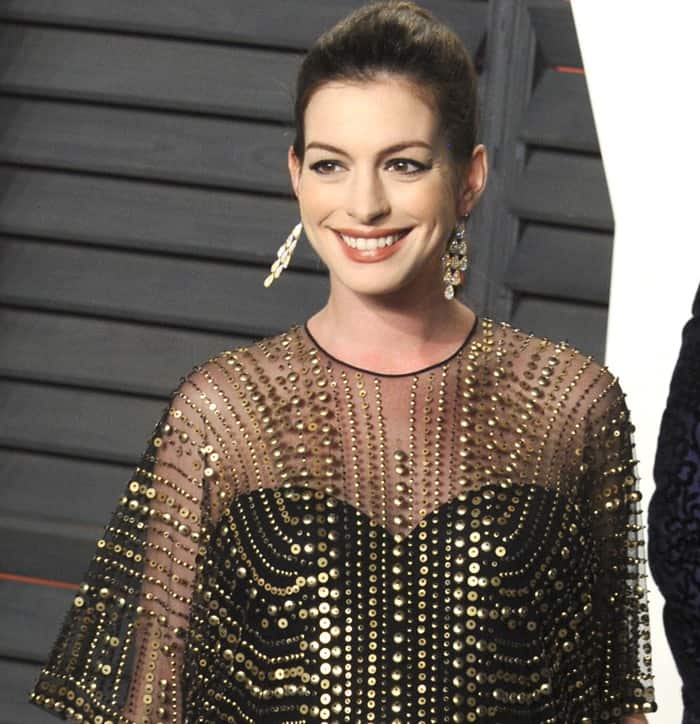 Anne Hathaway, who was pregnant with her first child, attended the 2016 Vanity Fair Oscars party in a stunning Naeem Khan maxi dress with intricate gold and black embellishments